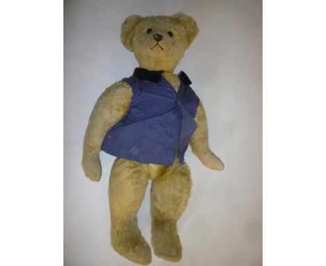 An English teddy bear, early to mid 20th century, straw filled, covered in pale gold plush, with swivel joints, black button 