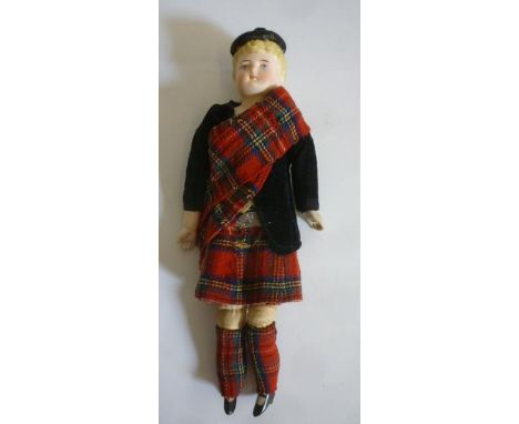 A bisque shoulder head doll with intaglio eyes, painted face, moulded hair, cloth body and limbs, composition lower arms and 