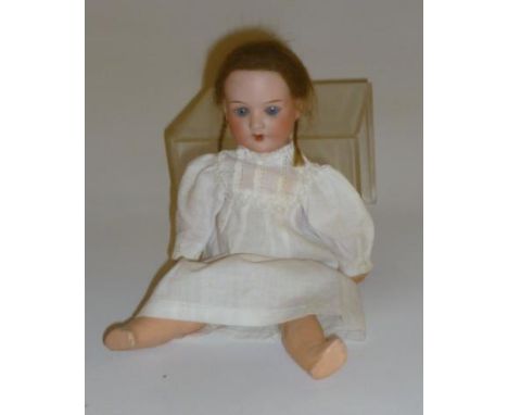 An Armand Marseille bisque head doll with blue glass sleeping eyes, open mouth and teeth, brown mohair wig, jointed compositi