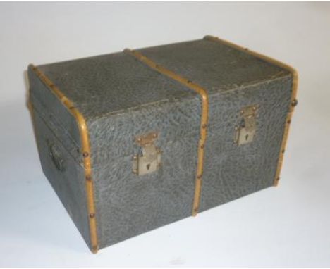 A doll's cabin trunk, wood bound and paper covered, 11" wide, 7" deep, containing a quantity of dolls' clothing in cotton, wo