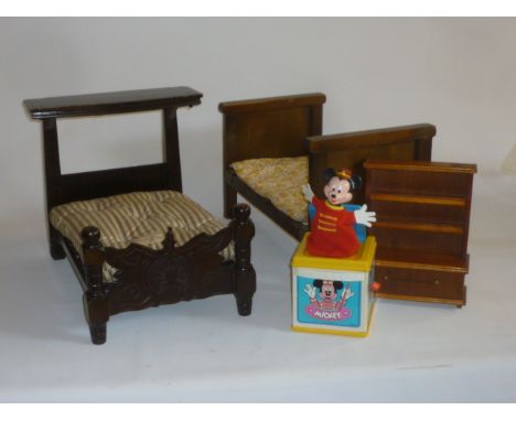 A dolls' stained wood half tester bedstead with carved footboard, and a Harrods mattress covered in striped ticking, 17 3/4" 