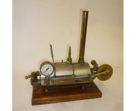 Stationary steam engine with stainless steel boiler, single cylinder, pressure gauge and brass fly wheel, no visible means of
