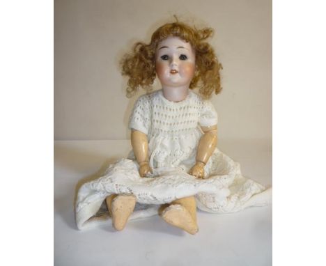 A Limbach "Wally" bisque head doll with blue glass sleeping eyes, open mouth and teeth, auburn mohair wig, jointed compositio