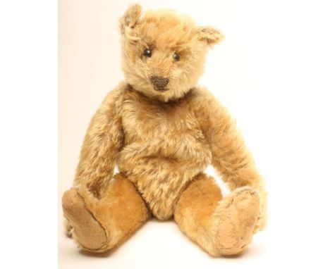 A Steiff "Archie" bear, c.1910, straw filled, covered in long gold plush, swivel limbs, button eyes, later felt pads, 12" hig