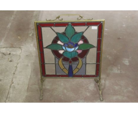 An early 20th century brass lead and stained glass fire screen.  Height 69 cm.  CONDITION REPORT: Used condition.  The glass 
