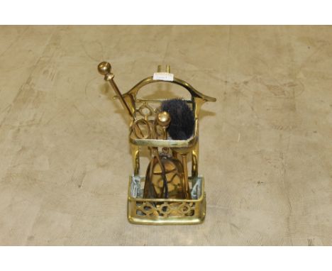 A small cast brass companion set with three fire tools. 30 cm x 18 cm. CONDITION REPORT: In used condition but generally good
