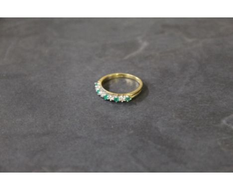 An 18 ct gold emerald and diamond ring, marked 750, with import marks, ring Size M/N, gross weight 2.5 grams. CONDITION REPOR