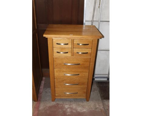 A modern light oak multi drawer chest, 112 cm x 68 cm x 50 cm. CONDITION REPORT: There are some minor marks etc but generally