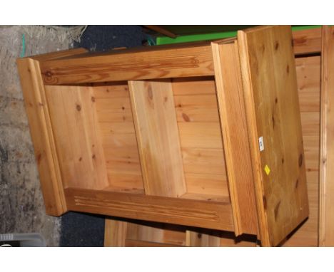 A modern pine open bookcase of small proportions with moulded top above a plain frieze and single adjustable shelf enclosed b