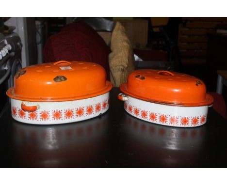 Two mid century enamelled metal casserole dishes, with stylised decoration, 36 cm and 32 cm. CONDITION REPORT: Some enamel lo