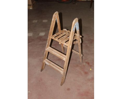 A small pair of vintage wooden step ladders, 93.5 cm high. CONDITION REPORT: In used condition, with paint splashes etc.