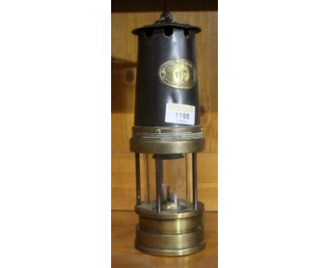 A Patterson Lamps Ltd. miners lamp numbered 110.  16 cm.  CONDITION REPORT: Used condition with some denting to body and cove