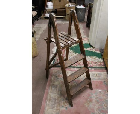 A set of vintage pine step ladders with iron hinges, 124 cm.  CONDITION REPORT: Used condition with paint splashes throughout