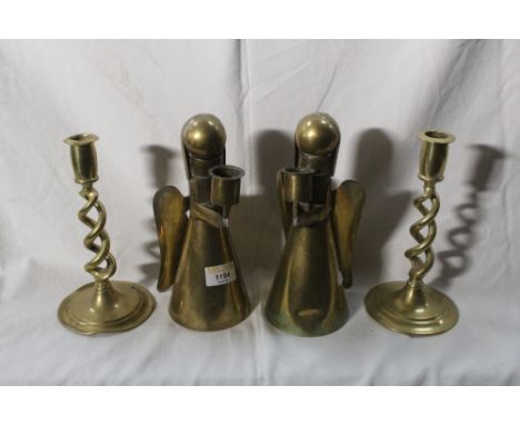 A pair of brass angel form candlesticks, 21.5 cm, sold together with a pair of twisted brass candlesticks, 20 cm.  CONDITION 