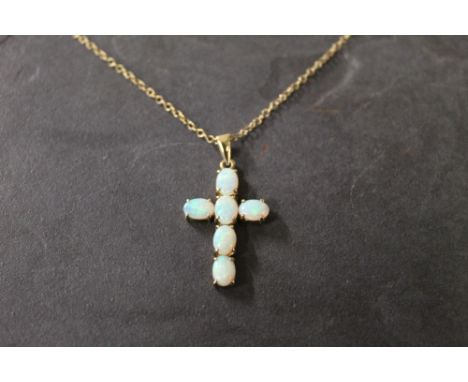 A 9 ct gold opal set crucifix pendant and fine link chain, 3 cm and 46 cm, gross weight 5.1 grams. CONDITION REPORT: In good 