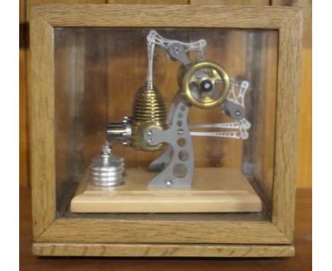 A modern oak cased pressure driven stationary engine with twin burners, 19.5 cm x 20 cm x 16.5 cm. CONDITION REPORT: Good use