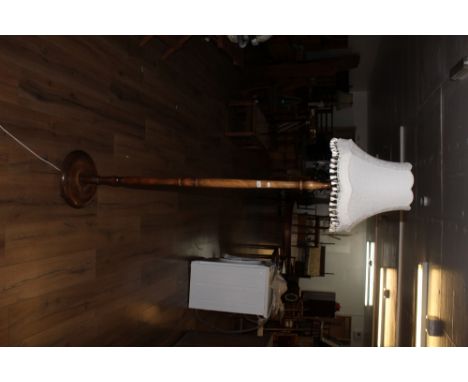 A turned beech wood standard lamp, with circular base. 150 cm to fitting. CONDITION REPORT: Some minor water marks and scuffi