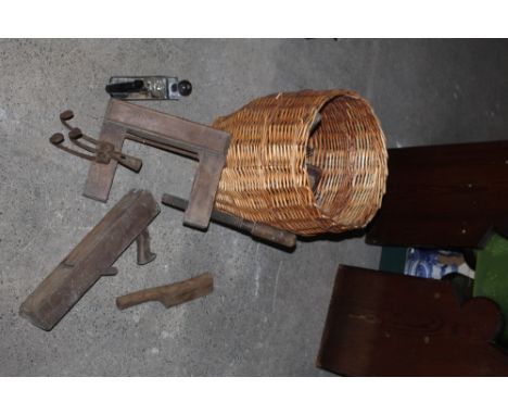 A woven wicker basket or bin containing various vintage wooden woodworking tools, to include a large clamp.  CONDITION REPORT