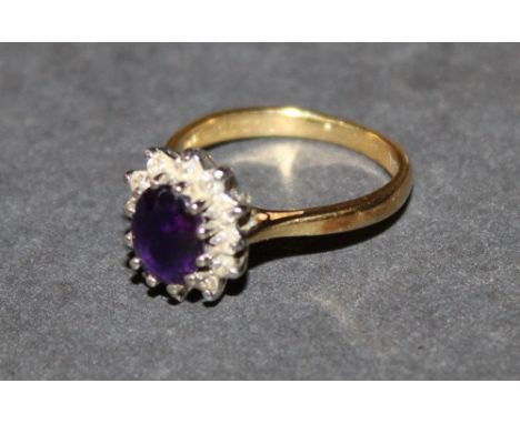 An 18 ct gold sapphire and diamond cluster ring, marked 18 ct, ring Size M, gross weight 4.4 grams. CONDITION REPORT: Some mi