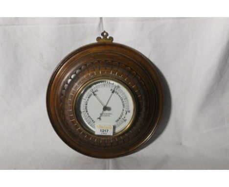 An early 20th century petal carved mahogany circular barometer by Dickson's of Chester, 26 cm diameter.  CONDITION REPORT: Ge