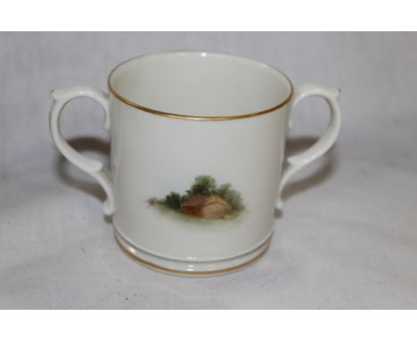 An early 20th century Royal Worcester loving cup, decorated with Worcester Cathedral and a small rural scene, the base marked