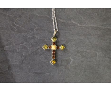A 925 grade white metal and amber specimen crucifix pendant and 925 grade white metal chain, dimensions crucifix 6 cm x 4.5 c
