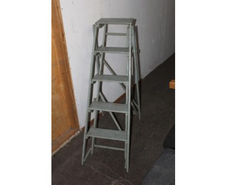 A vintage blue painted folding step ladder. 146 cm in length.  CONDITION REPORT: Used condition with paint splashes, edge wea
