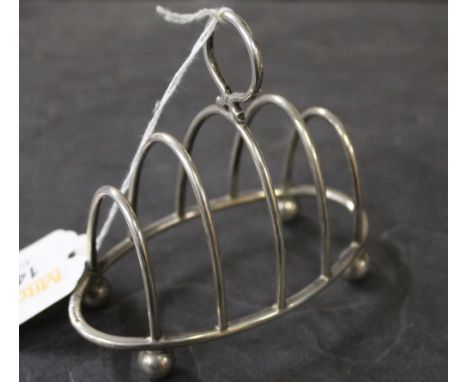 An early 20th century silver four division oval toast rack, marks for Birmingham 1908, maker Haseler Brothers, length 10 cm, 