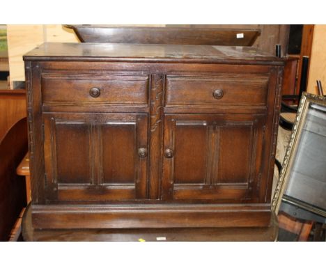 A small Ercol dark elm sideboard, 71 x 97.5 x 50 cm. CONDITION REPORT: Generally good condition, some fine scratching etc, so