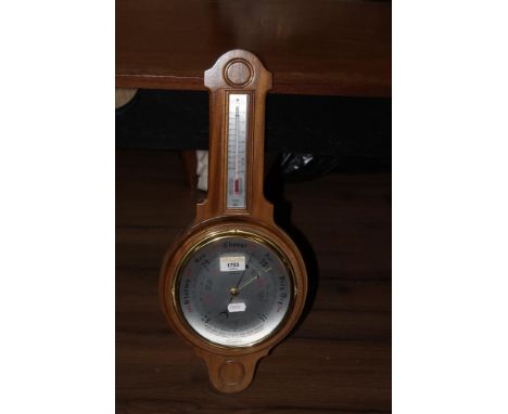 A vintage wheel barometer and thermometer, British instrument made. 50 cm x 22 cm.    CONDITION REPORT: Generally good used c