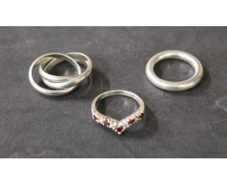 Three white metal and 925 grade rings, comprising Russian style wedding ring, a plain band and a red and white stone set ring