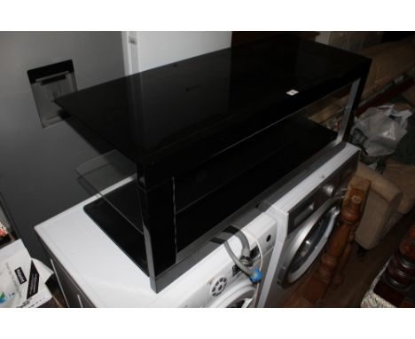 A modern black and clear glass rectangular TV / media stand, with central clear glass shelf, 41 cm x 105 cm x 41 cm. CONDITIO