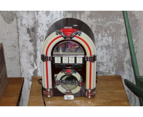 A modern Wurlitzer juke box style radio/cd player with USB facility. 38 cm x 26 cm. CONDITION REPORT: Some yellowing to the p