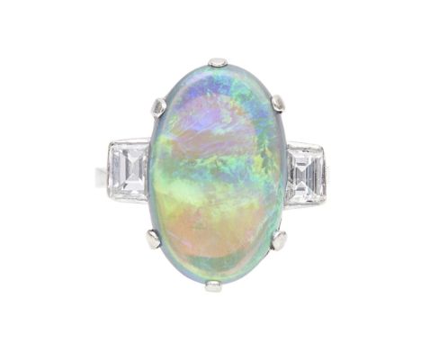 An opal and diamond set ring    claw set with a black opal, flanked to either side by a collet set baguette cut diamond, to a