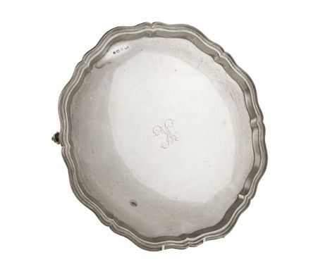 A large salver    EV, Sheffield 1933, of circular form, moulded rim, engraved K to centre, all raised on three scroll feet   