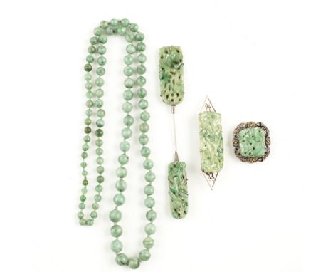 A collection of jade jewellery    to include a graduated bead necklace; a jabot pin, each terminal set with a carved jade pan