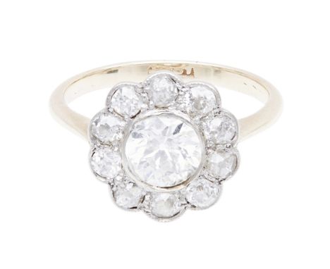 An early 20th century diamond set cluster ring    collet set with an old-round cut diamond, in a border of old-round and cush
