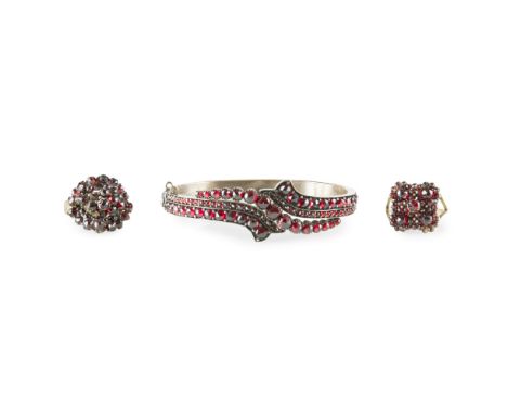 A collection of garnet set jewellery    to include two garnet set cluster rings and a hinged garnet set bangle, all unmarked 