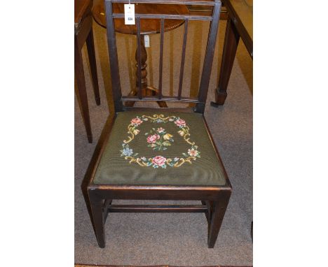 A 19th Century single dining chair, the drop-in seat upholstered in woolwork tapestry, raised on square tapering legs joined 