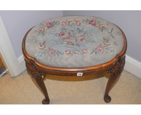 A 19th Century oval mahogany stool, the drop-in seat upholstered in hand-worked tapestry in floral design, raised on carved c