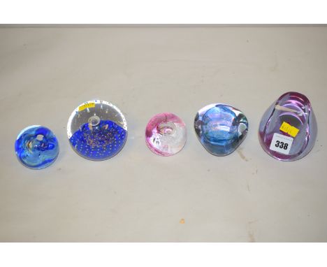 Three Caithness glass paperweights titled 'Valhalla'; 'Pebble' and 'Moon Crystal'; together with two others monogrammed C.G. 