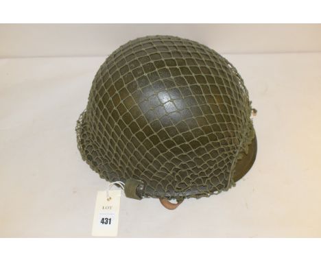 An American WWII helmet with green mesh.
