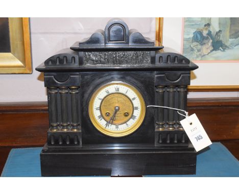 A Victorian black slate mantle clock with roman dial presented to Mr E.W. Penry for commended increase done during 1908.