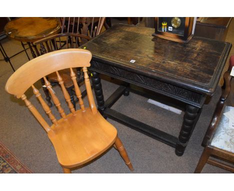 A 19th/early 20th Century stained oak side table with carved frieze, raised on bobbin turned legs joined by stretchers, 92cms