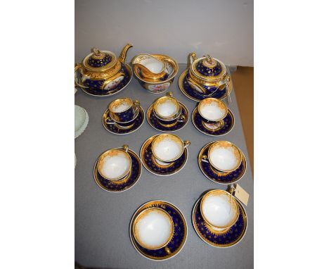 A Victorian hand-painted part tea service, on blue ground with gilt decoration, to include: teapot, sugar bowl and cover, cre