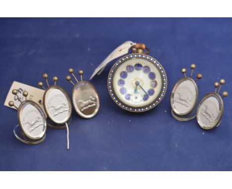 A brass and glass ball clock with white and blue enamel dial, gilded decoration and open back; and five plaques inscribed "De