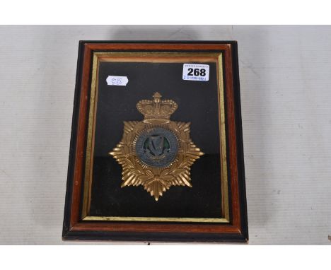 A CONNOUGHT RANGERS HELMET PLATE, this is framed and mounted and the helmet plate features a gilt crown and star with laurel 