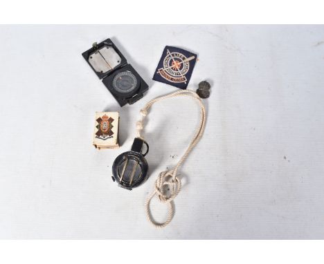 A SELECTIONS OF MILITARY RELATED ITEMS, to include two compasses, a matchbox cover, ARP badge and a blazer badge, the first c