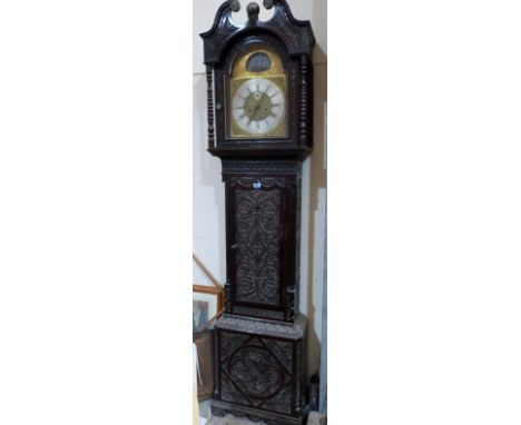 A 19th century oak longcase clock, with 8 day movement, the case later carved, the breakarch dial with silvered chapter and s