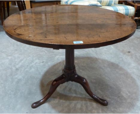 A 19th century oak tripod table, the round top on gun barrel column support. 30' diam.